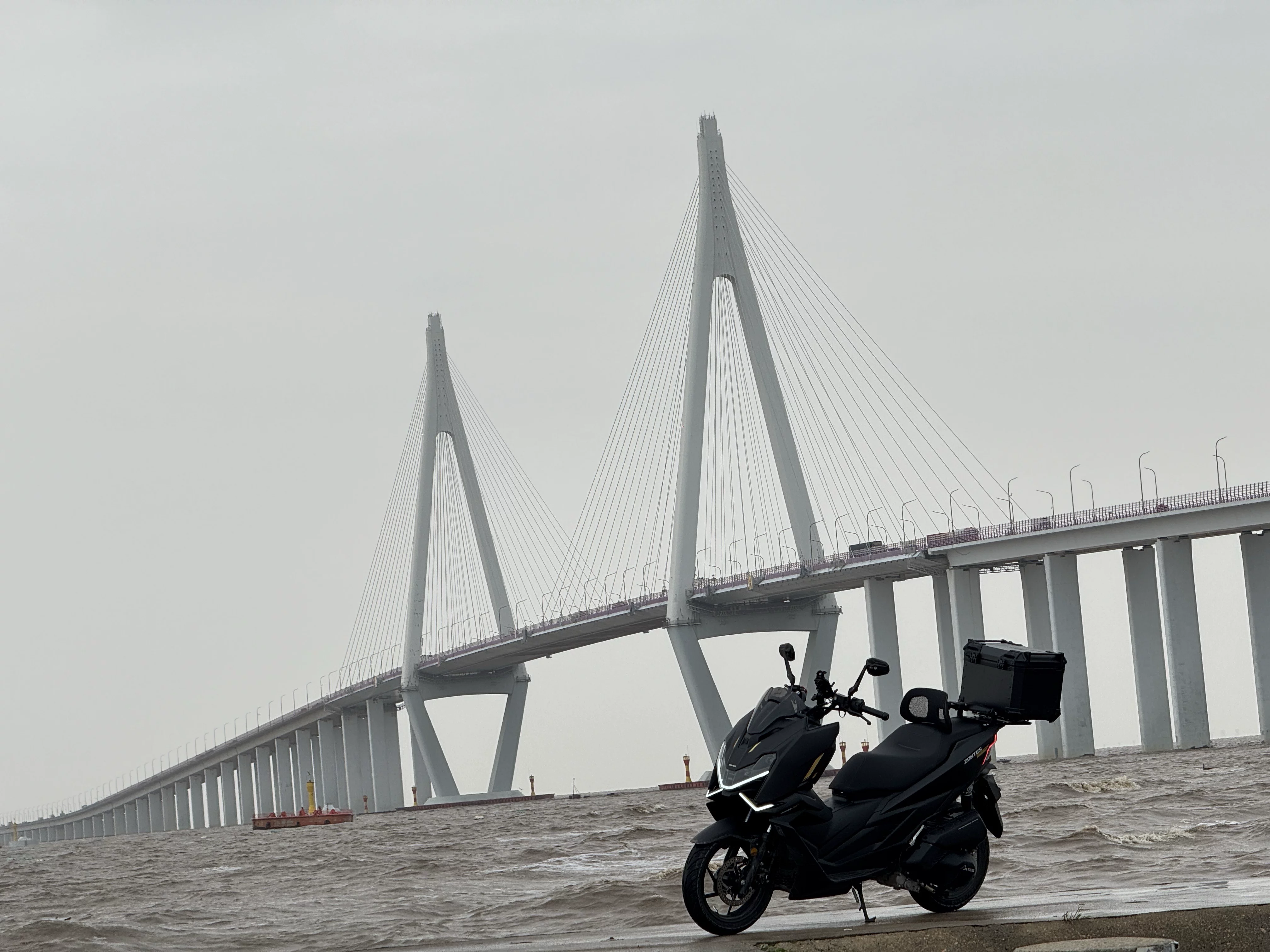 TUBAN installed on a scooter near a bridge