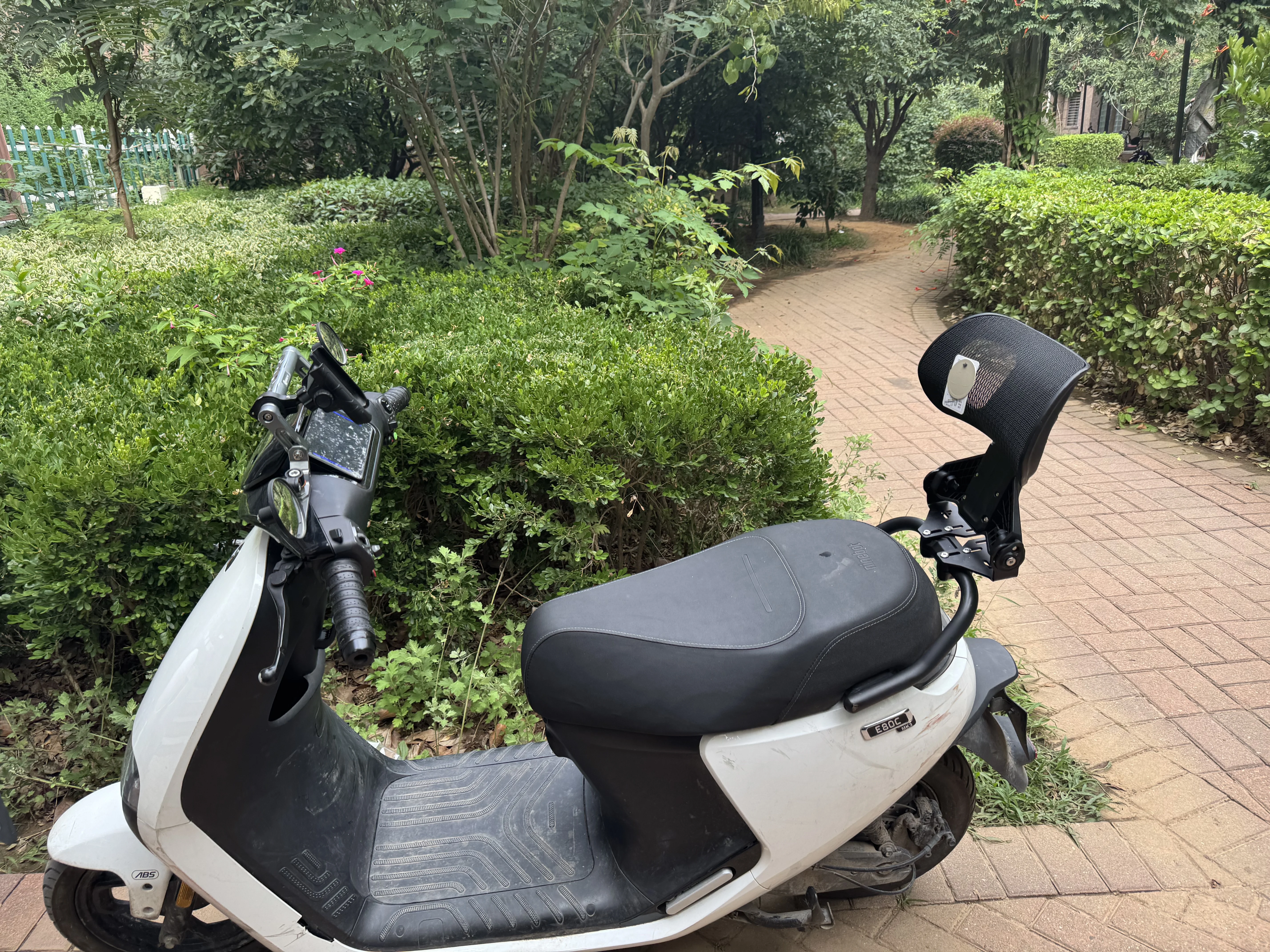 TUBAN installed on a scooter near a park path